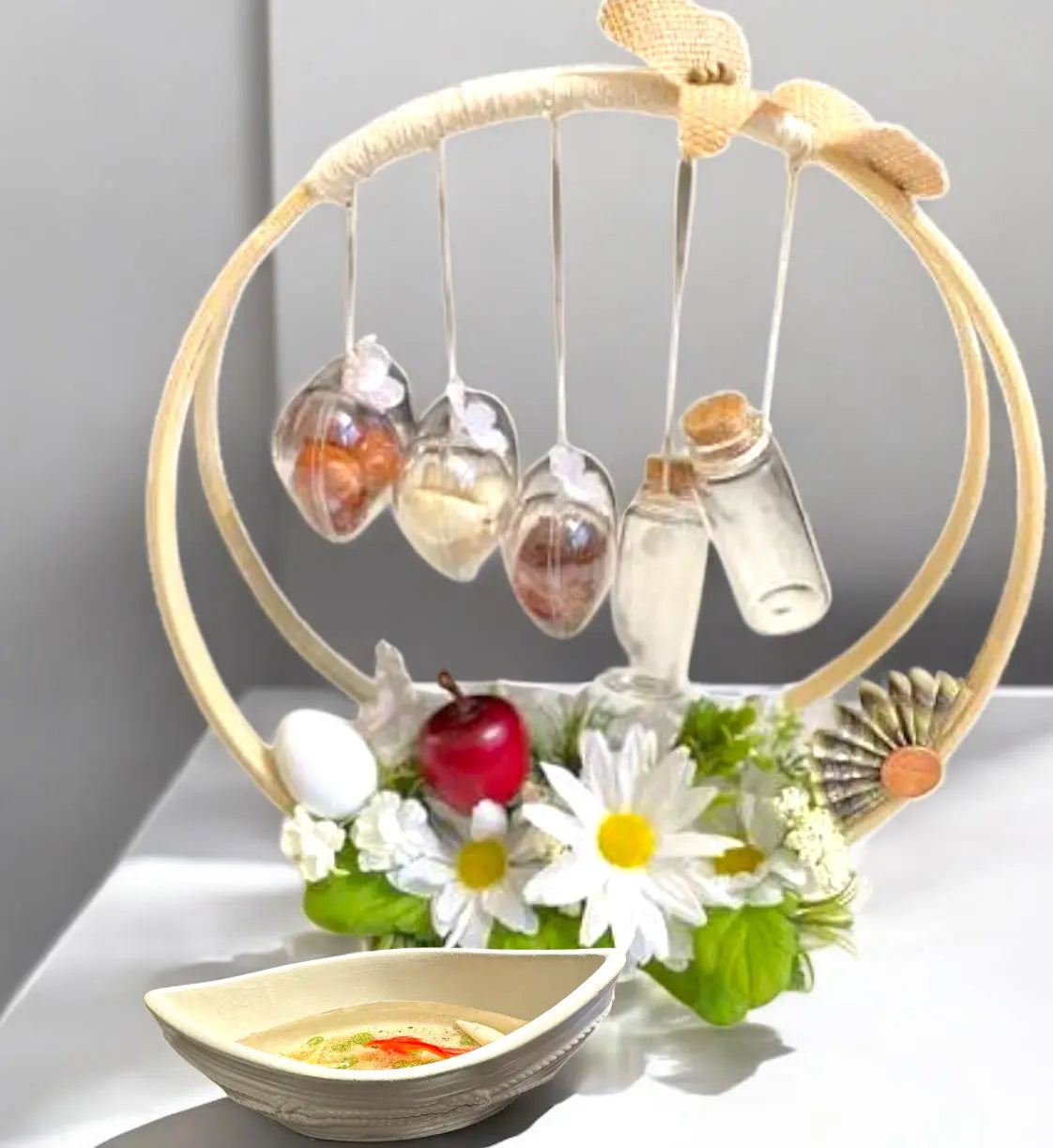 Handcrafted decorative hanging display with glass orbs and flowers, featuring a stylish epoxy resin serving tray.