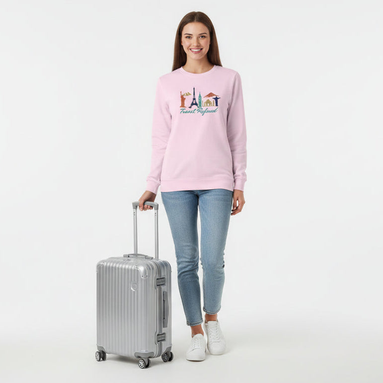 Pink long-sleeve shirt with travel-themed design and 'Travel Refined' text on a white background