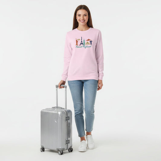 Pink long-sleeve shirt with travel-themed design and 'Travel Refined' text on a white background