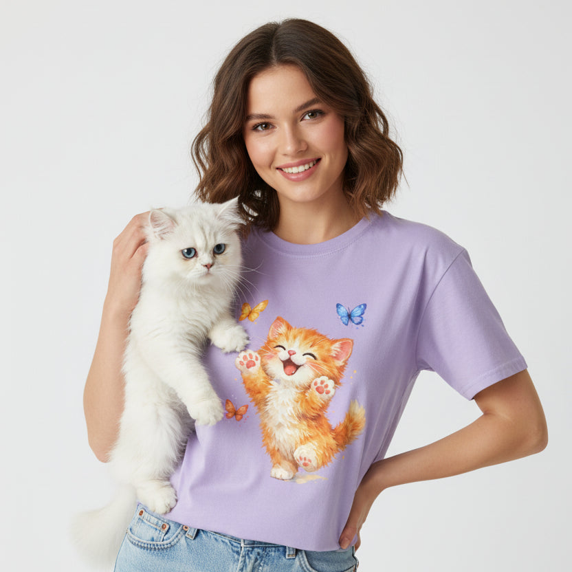 Purple t-shirt with a cartoon cat and butterflies design on a white background