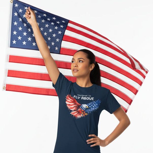 Navy blue t-shirt with an eagle design and 'Designed to Fly Above' text on a white background