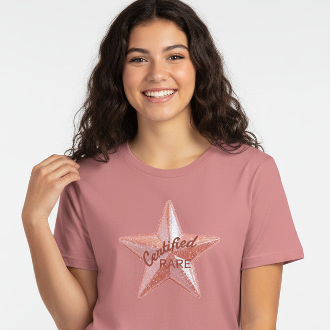 Pink t-shirt with a star graphic and text on a white background